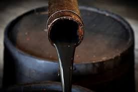 Crude oil pouring from a barrel spout